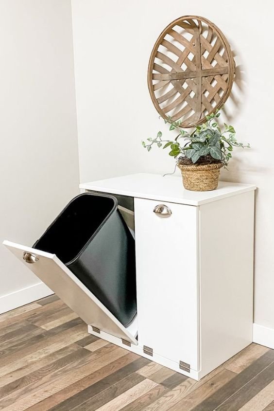 Integrated pull-out trash and recycling hidden in kitchen cabinetry