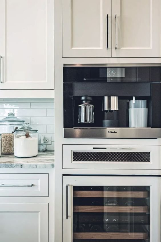 Integrated appliances hidden behind cabinet panels in a zen kitchen