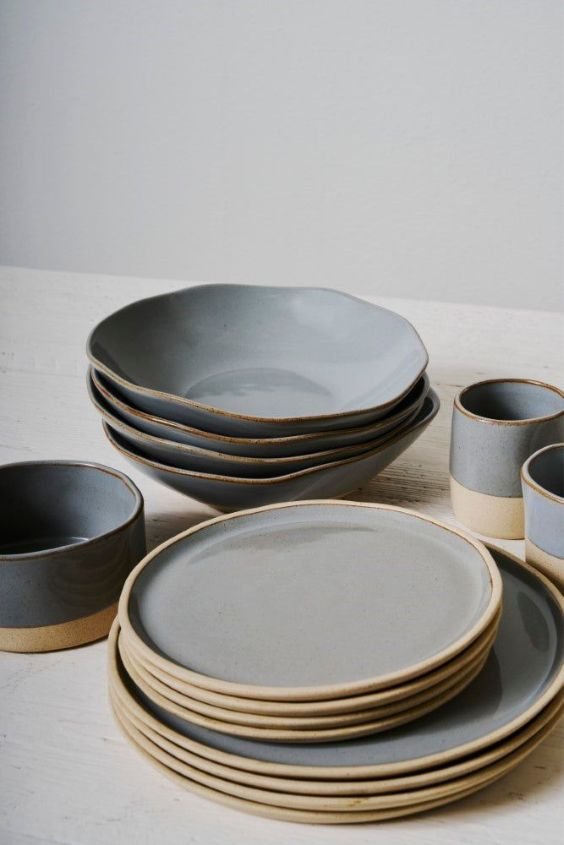 Wabi-sabi ceramic dishware displayed on open shelves in a zen kitchen