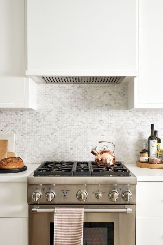 Plastered streamlined vent hood in a clean minimalist zen kitchen